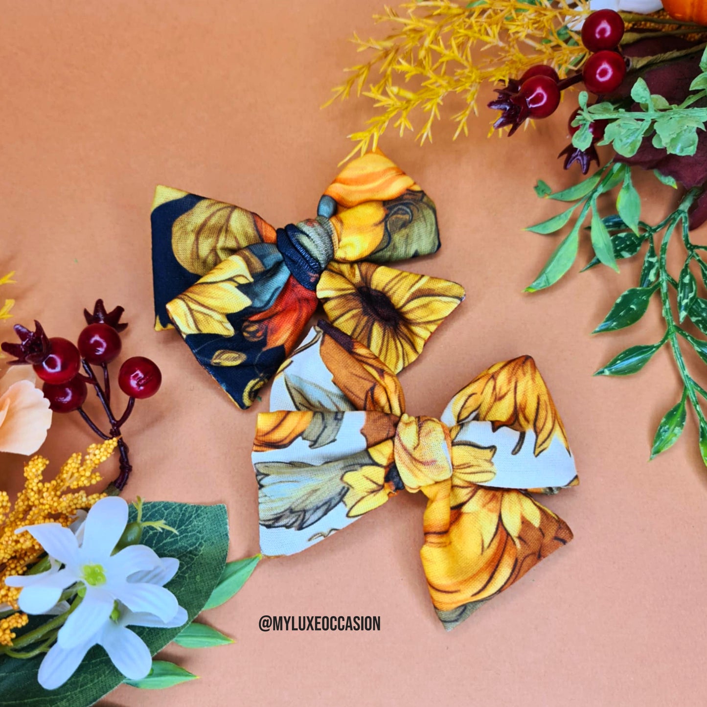 Two floral bows on a decorative background with flowers and leaves.
