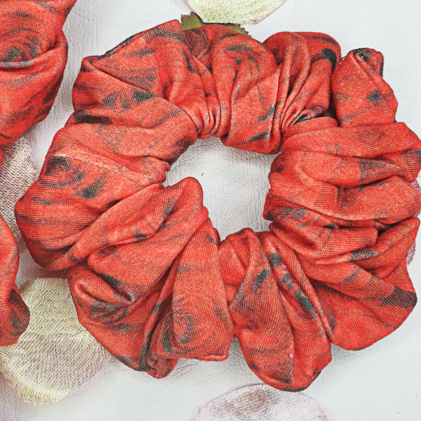 Add a touch of boldness to your hair with our Red and Black Roses Scrunchie! Handmade by myluxeoccasion, this scrunchie guarantees no wilted flowers.