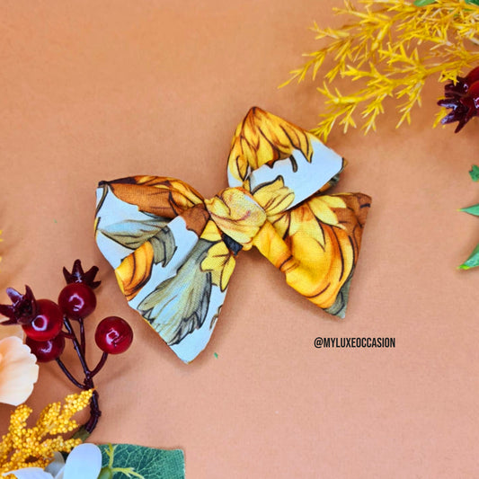 Beige floral bow with decorative elements on a peach background