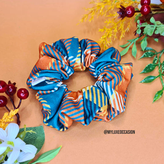 Autumn Tartan scrunchie on a peach background with floral decorations