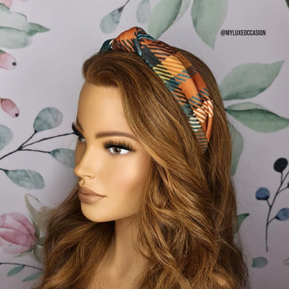 Mannequin head with a tartan headband against a floral background