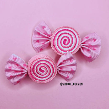 pink candy swirl hair clips with  heart details bows on pastel pink background